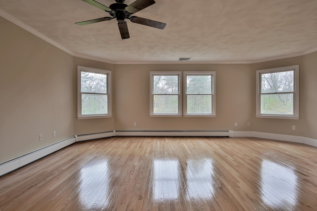 209 Main Street Boxford, MA 01921 - Photo 16 of 30 a view of an empty room with wooden floor and a window