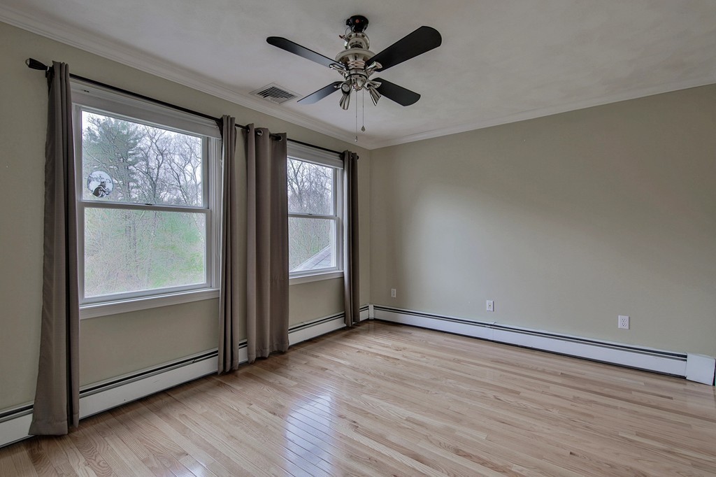 209 Main Street Boxford, MA 01921 - Photo 19 of 30 an empty room with wooden floor and windows