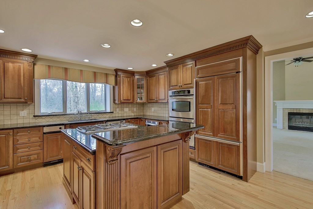 209 Main Street Boxford, MA 01921 - Photo 3 of 30 a kitchen with stainless steel appliances granite countertop a sink a stove a refrigerator and cabinets