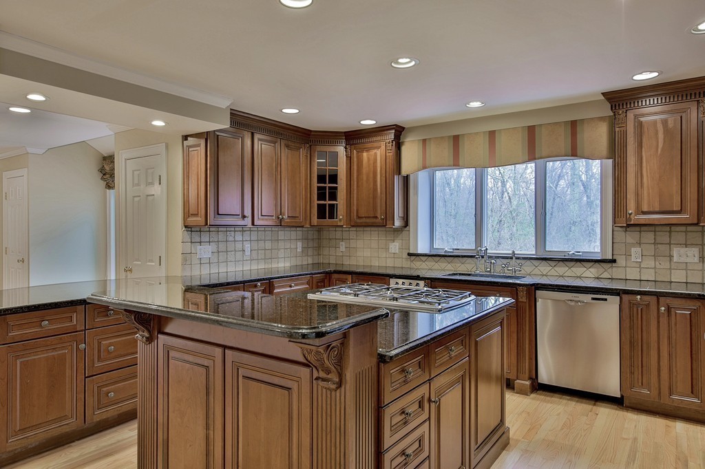 209 Main Street Boxford, MA 01921 - Photo 5 of 30 a kitchen with a sink stove and cabinets