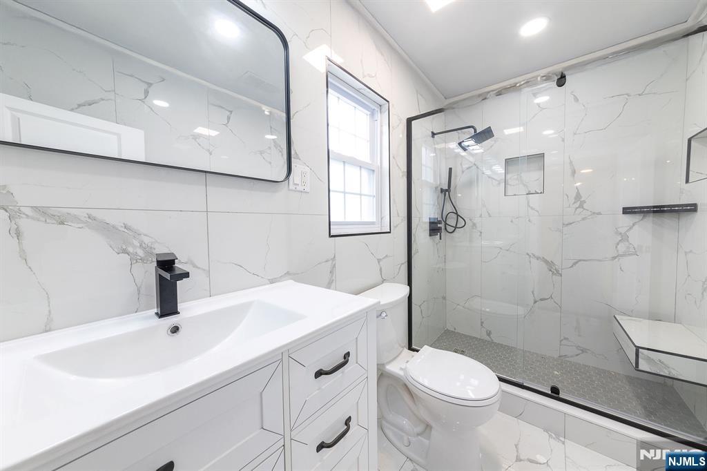 34 Kearny Street Lyndhurst, NJ 07071 - Photo 14 of 29 a bathroom with a sink a toilet and shower