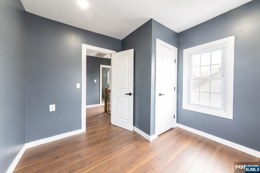 34 Kearny Street Lyndhurst, NJ 07071 - Photo 19 of 29 a view of an empty room with wooden floor and a window