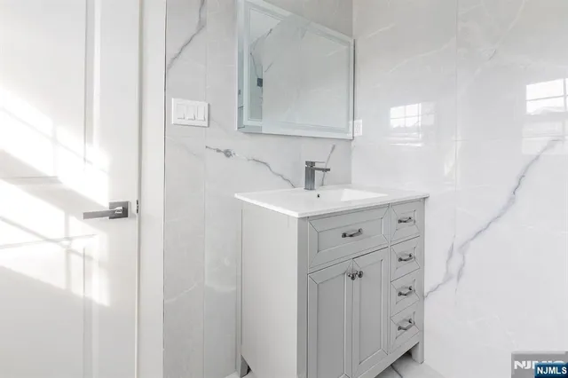 a bathroom with a sink vanity and mirror