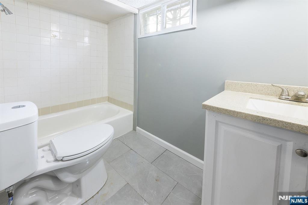 34 Kearny Street Lyndhurst, NJ 07071 - Photo 26 of 29 a white toilet sitting next to a bathroom sink