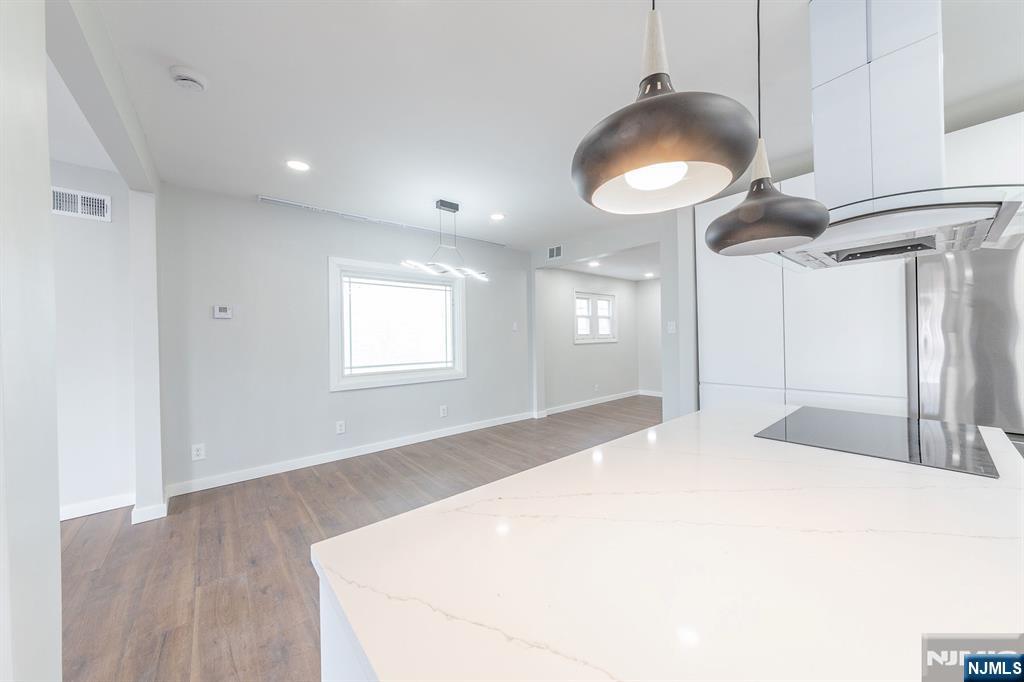 34 Kearny Street Lyndhurst, NJ 07071 - Photo 9 of 29 a large white room with wooden floor and chandelier