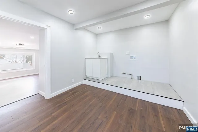 a view of a room with wooden floor and cabinet