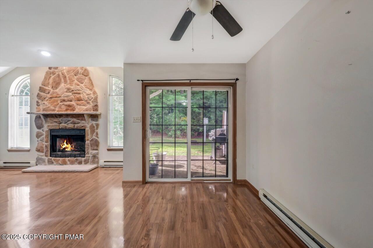 613 Country Acres Court Effort, PA 18330 - Photo 11 of 40 a view of empty room with wooden floor and fireplace