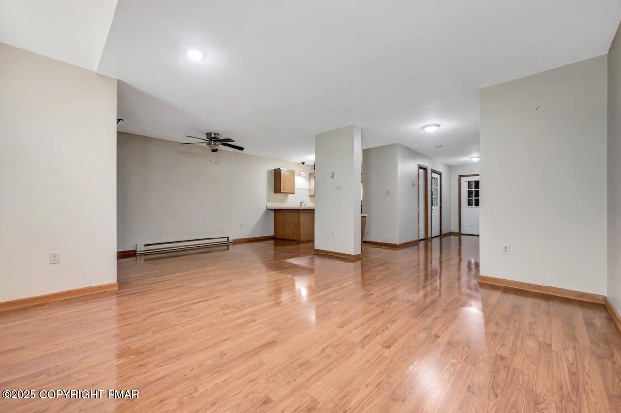 613 Country Acres Court Effort, PA 18330 - Photo 12 of 40 a view of a big room with wooden floor and a window
