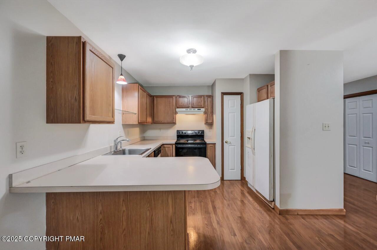 613 Country Acres Court Effort, PA 18330 - Photo 14 of 40 a kitchen with a sink a refrigerator and wooden floor