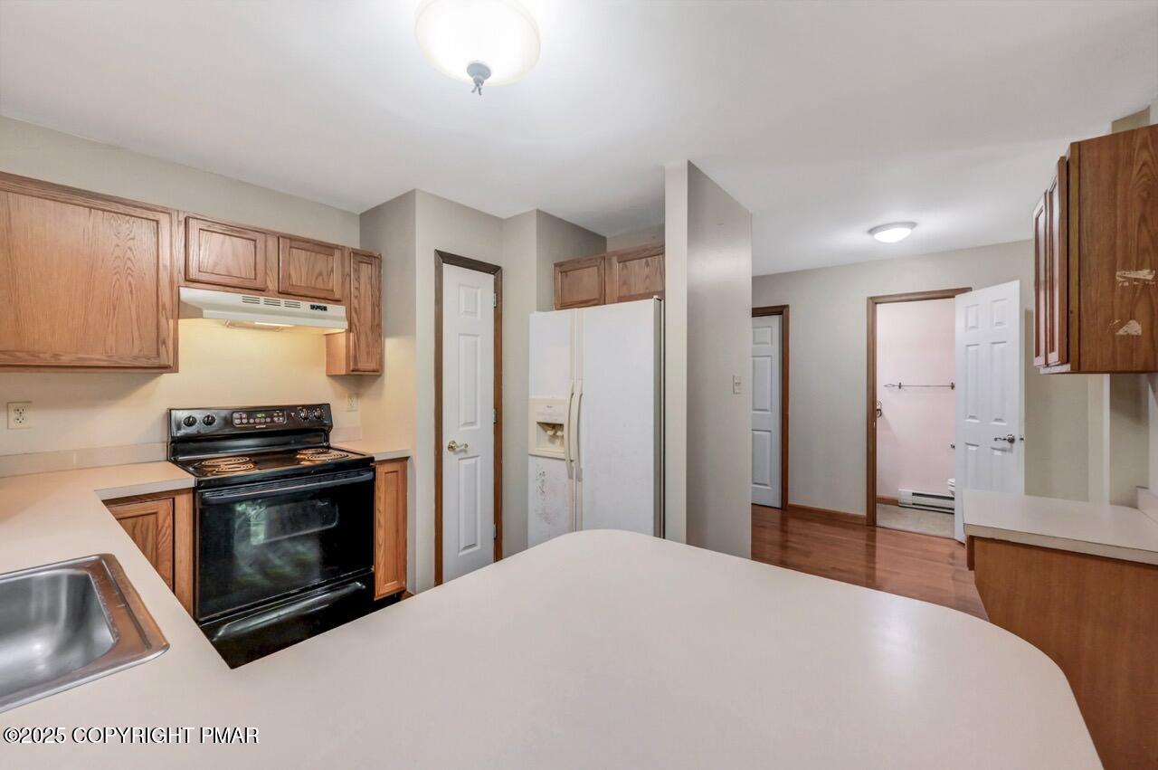 613 Country Acres Court Effort, PA 18330 - Photo 17 of 40 a kitchen with stainless steel appliances a stove a refrigerator and a sink