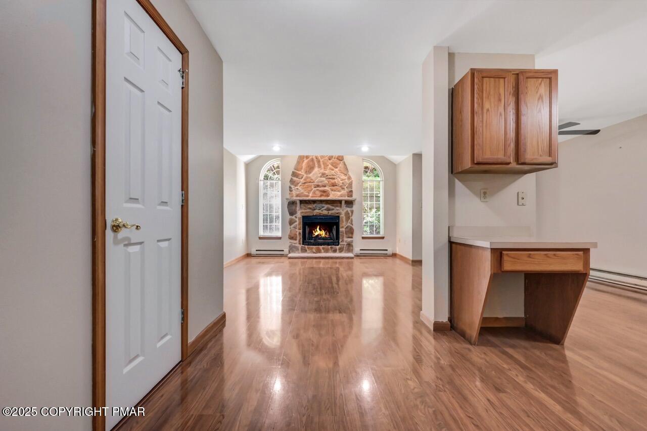613 Country Acres Court Effort, PA 18330 - Photo 5 of 40 a hallway with fireplace and wooden floor