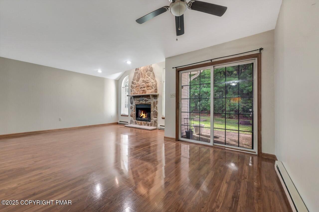 613 Country Acres Court Effort, PA 18330 - Photo 10 of 40 a view of empty room with wooden floor and fireplace