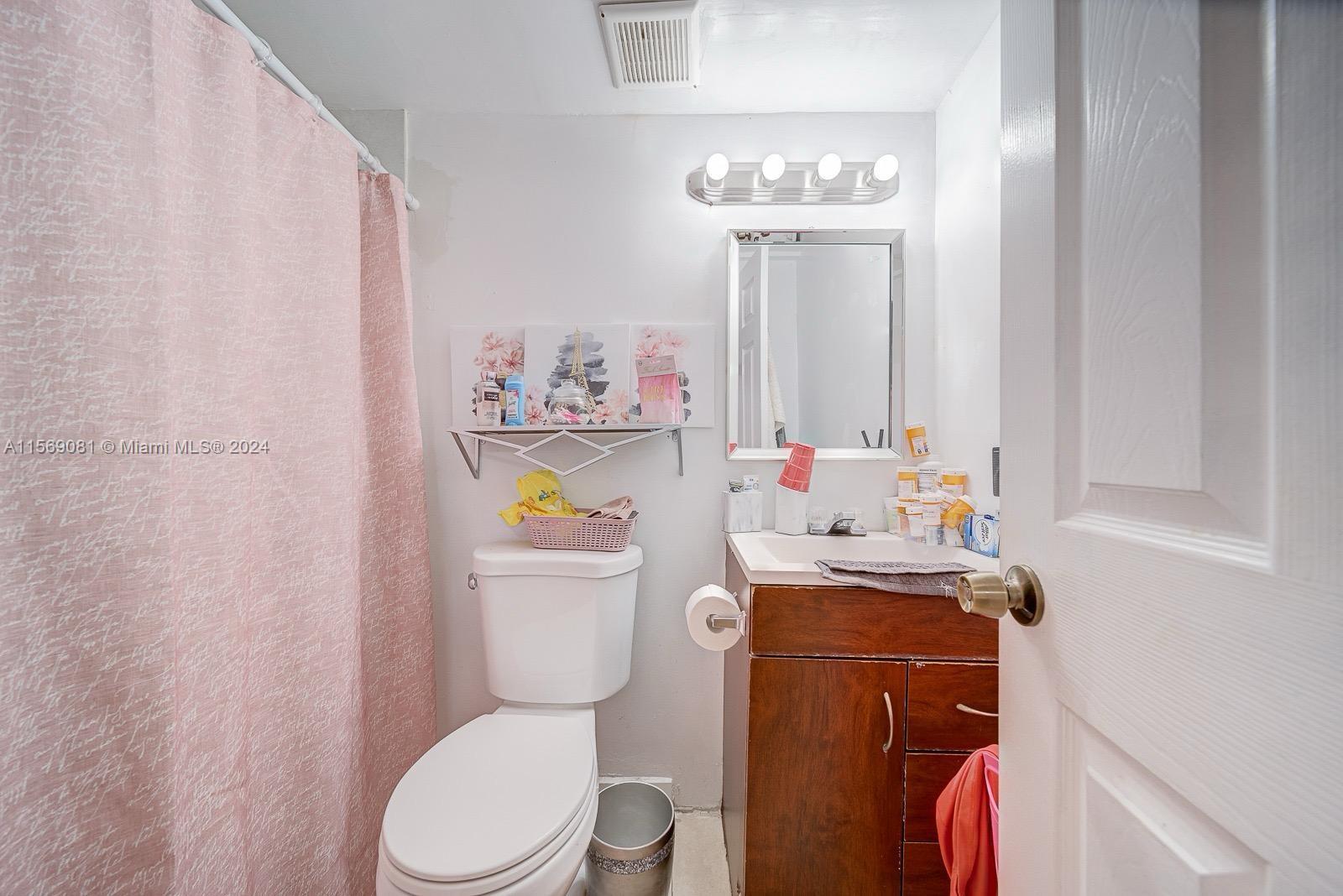627 Southwest 11th Avenue Miami, FL 33130 - Photo 11 of 15 a bathroom with a sink a toilet and a mirror