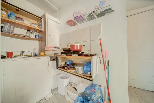 a kitchen with a refrigerator and cabinets