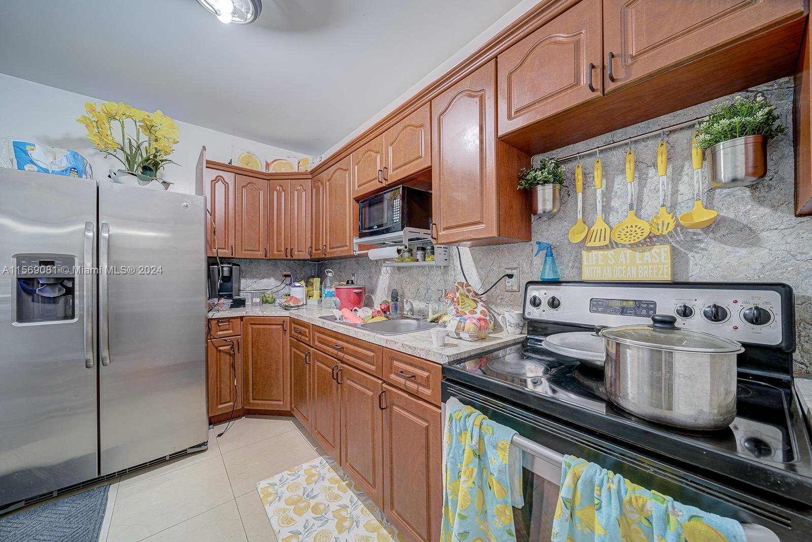 627 Southwest 11th Avenue Miami, FL 33130 - Photo 6 of 15 a kitchen with stainless steel appliances granite countertop a stove a sink dishwasher and a refrigerator