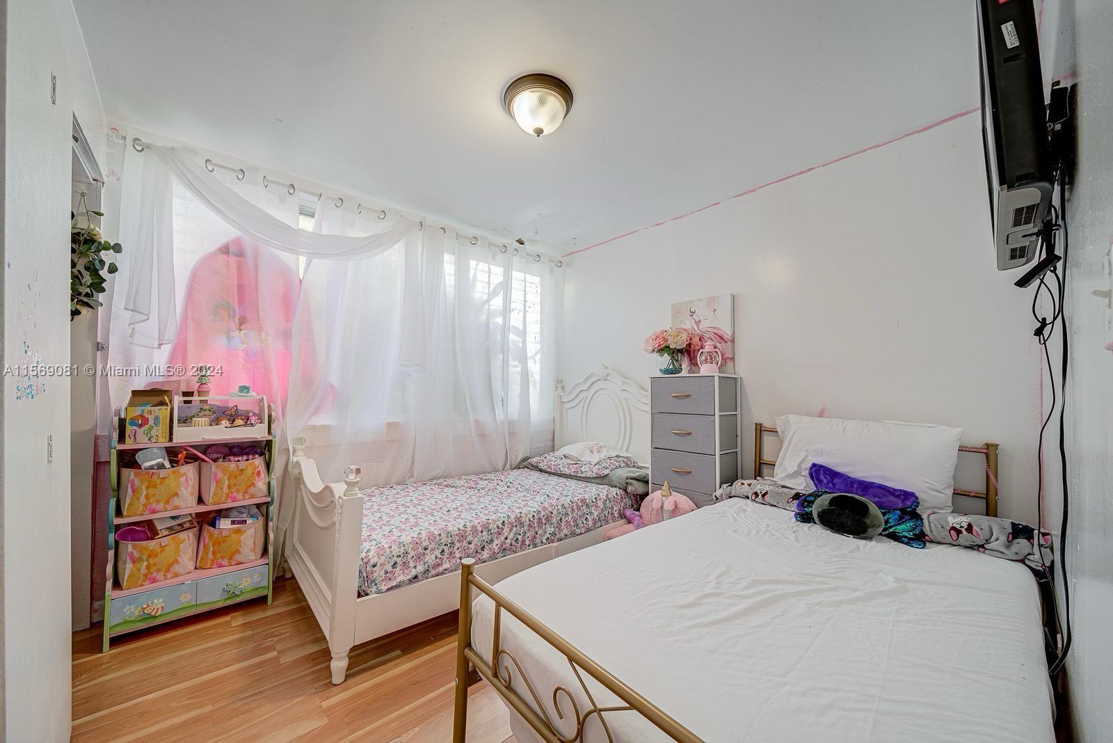 627 Southwest 11th Avenue Miami, FL 33130 - Photo 7 of 15 a bedroom with a bed and a flat screen tv