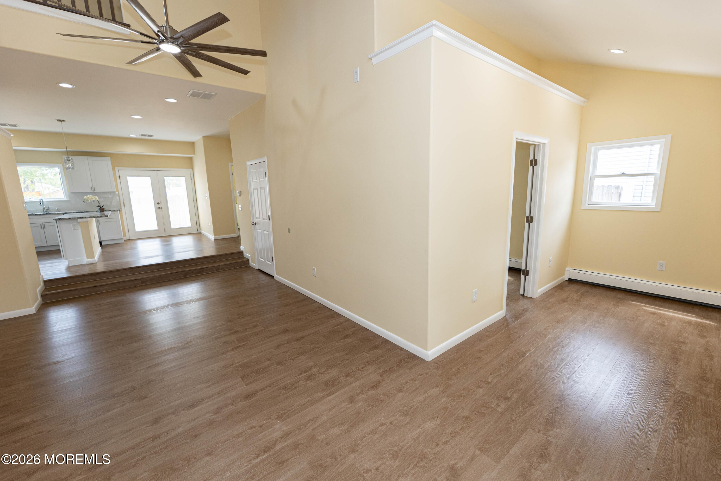 2408 Herbertsville Road Point Pleasant, NJ 08742 - Photo 20 of 82 an empty room with wooden floor a ceiling fan and windows