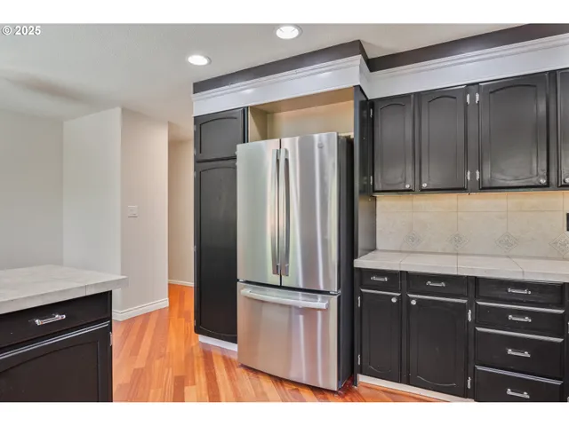 a kitchen with a refrigerator and cabinets