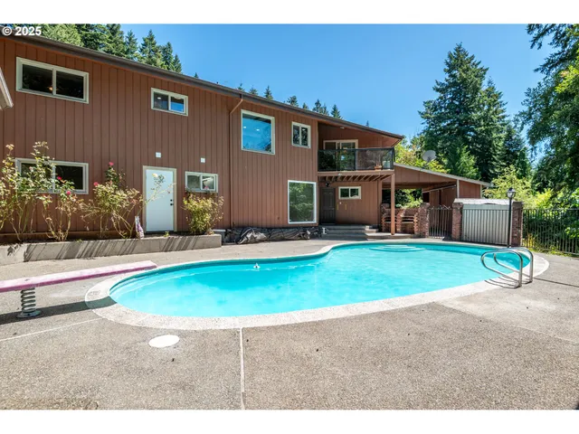 a swimming pool with outdoor seating and yard