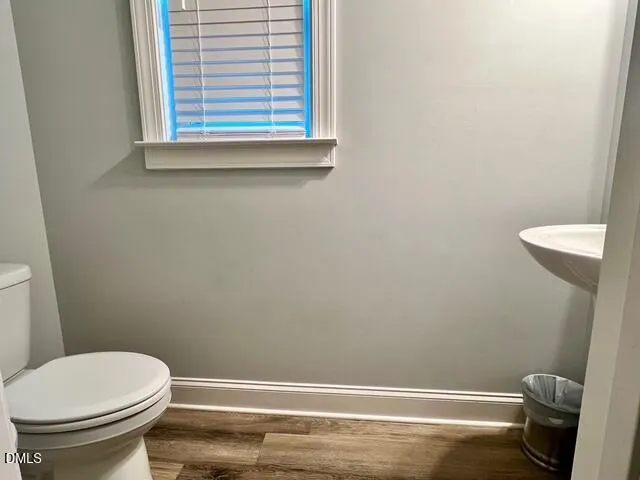 a bathroom with a toilet and a window