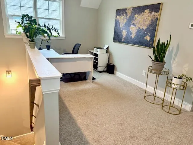 a living room with furniture and flowers