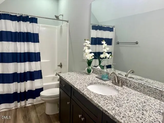 a bathroom with a sink a toilet a shower and a mirror