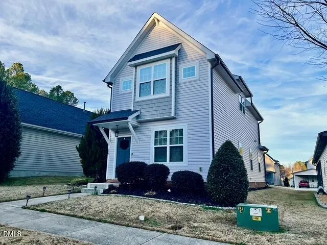 a view of a house with a yard and plants