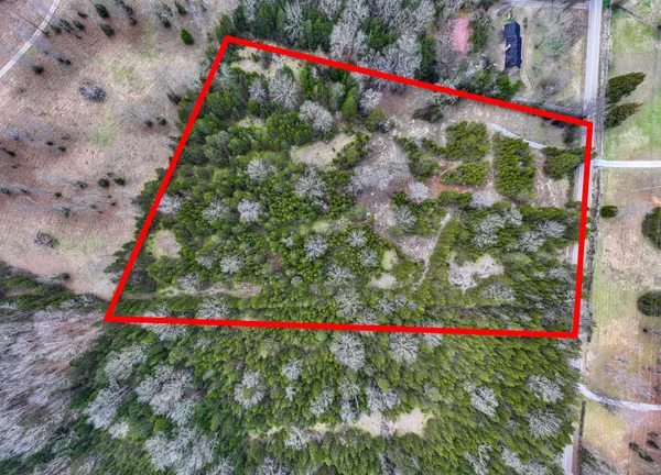 a small white swimming pool is in front of the house