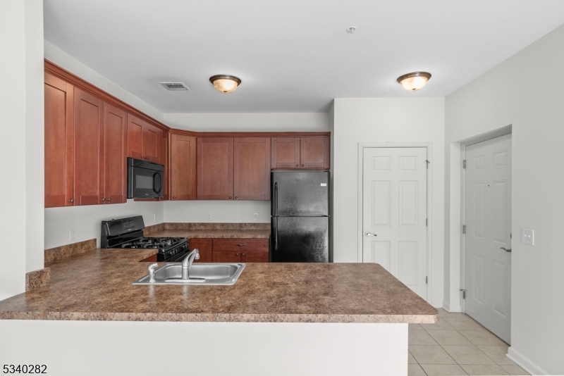 41 Park Drive, Unit 41 Clinton, NJ 08809 - Photo 13 of 38 a kitchen with stainless steel appliances granite countertop a refrigerator and a sink