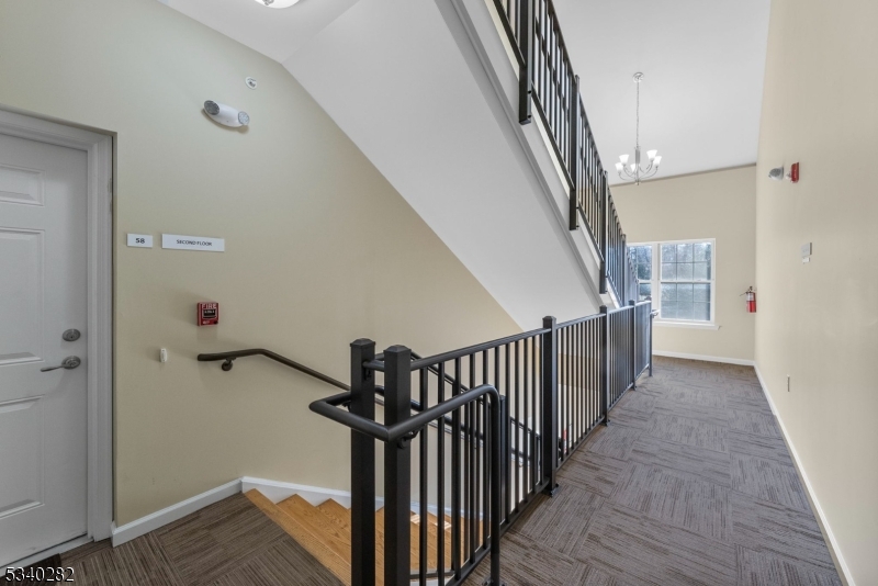 41 Park Drive, Unit 41 Clinton, NJ 08809 - Photo 31 of 38 a view of a hallway with wooden floor and staircase