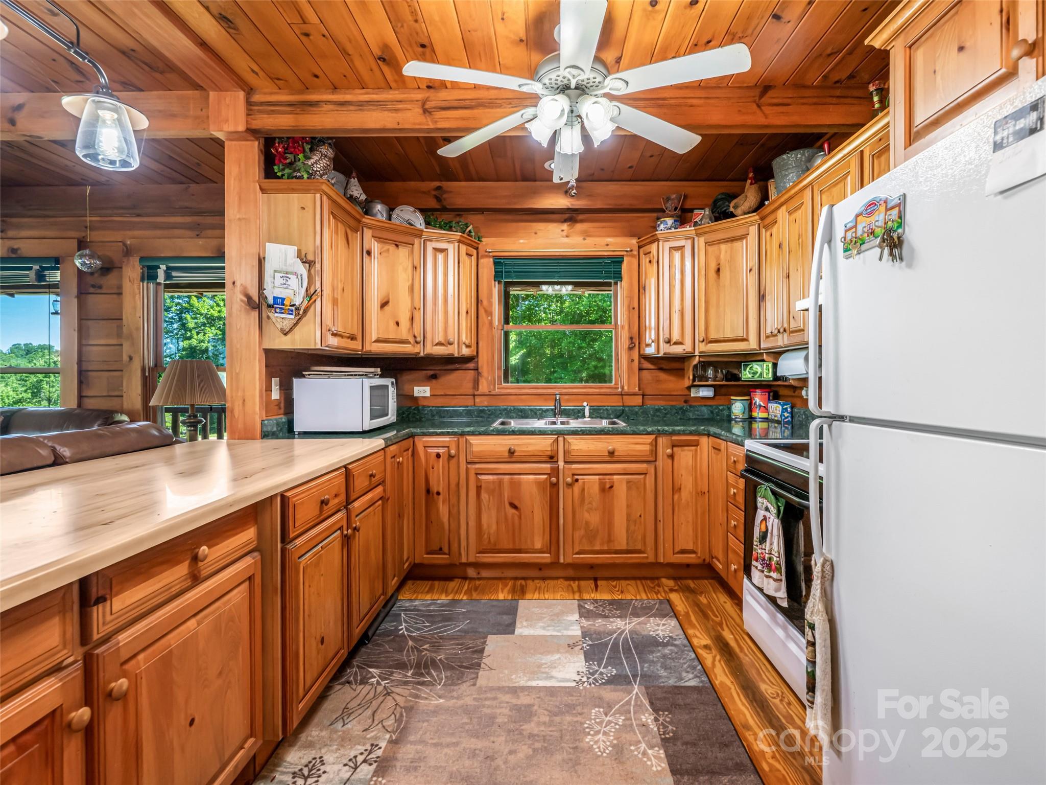 129 Melrose Lake Road Saluda, NC 28773 - Photo 13 of 48 a kitchen with stainless steel appliances granite countertop a sink and a stove