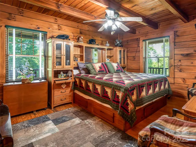 a bedroom with a bed next to a large window