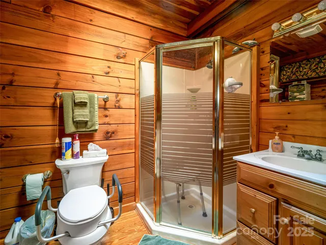 a bathroom with a sink mirror toilet and shower