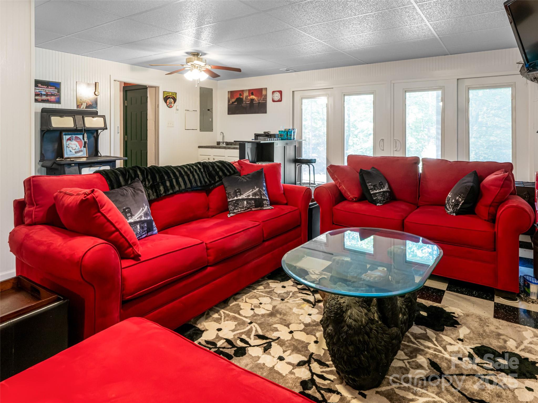 129 Melrose Lake Road Saluda, NC 28773 - Photo 23 of 48 a living room with furniture a rug and a chandelier