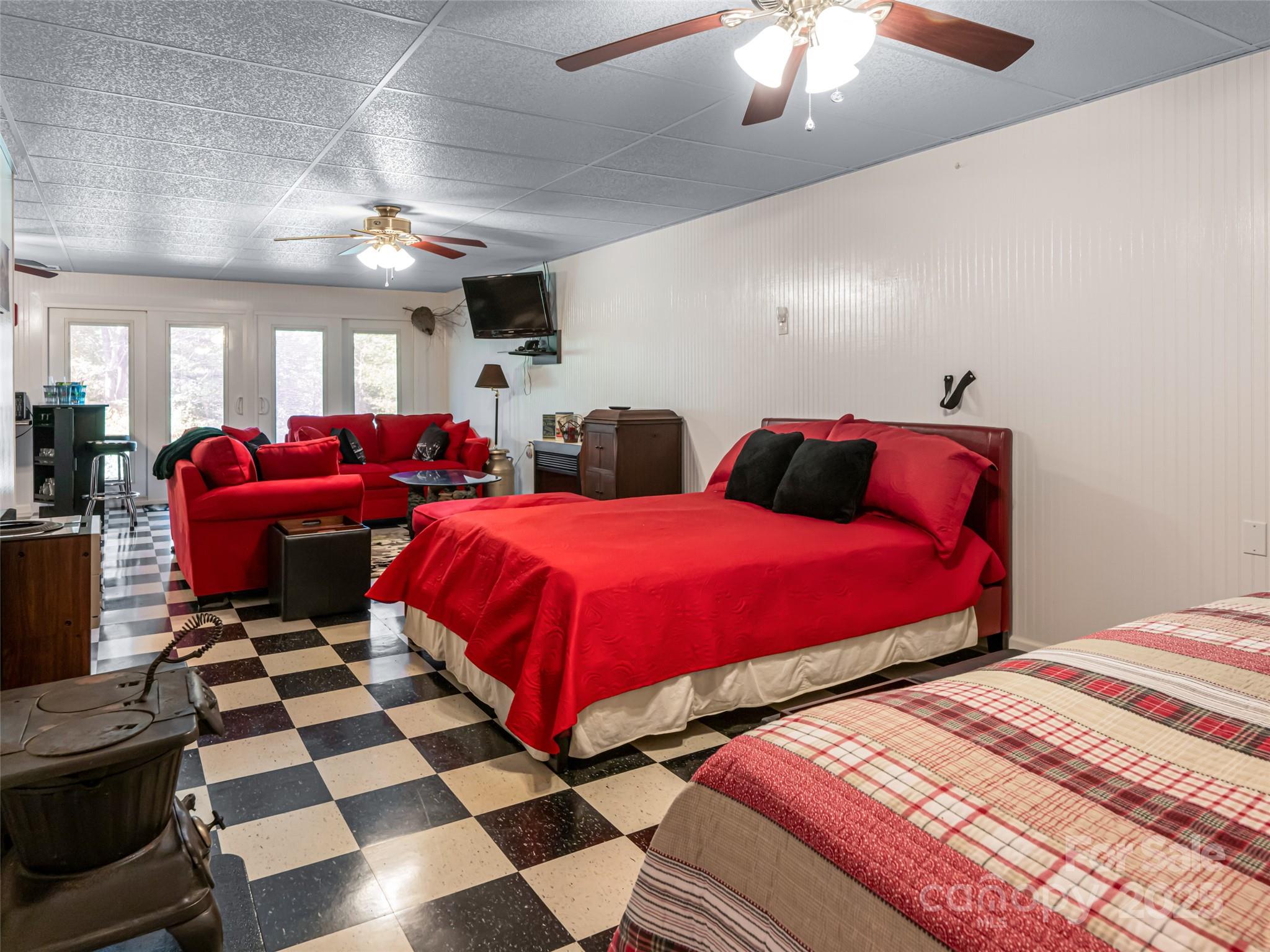 129 Melrose Lake Road Saluda, NC 28773 - Photo 26 of 48 a bedroom with double bed and a mirror