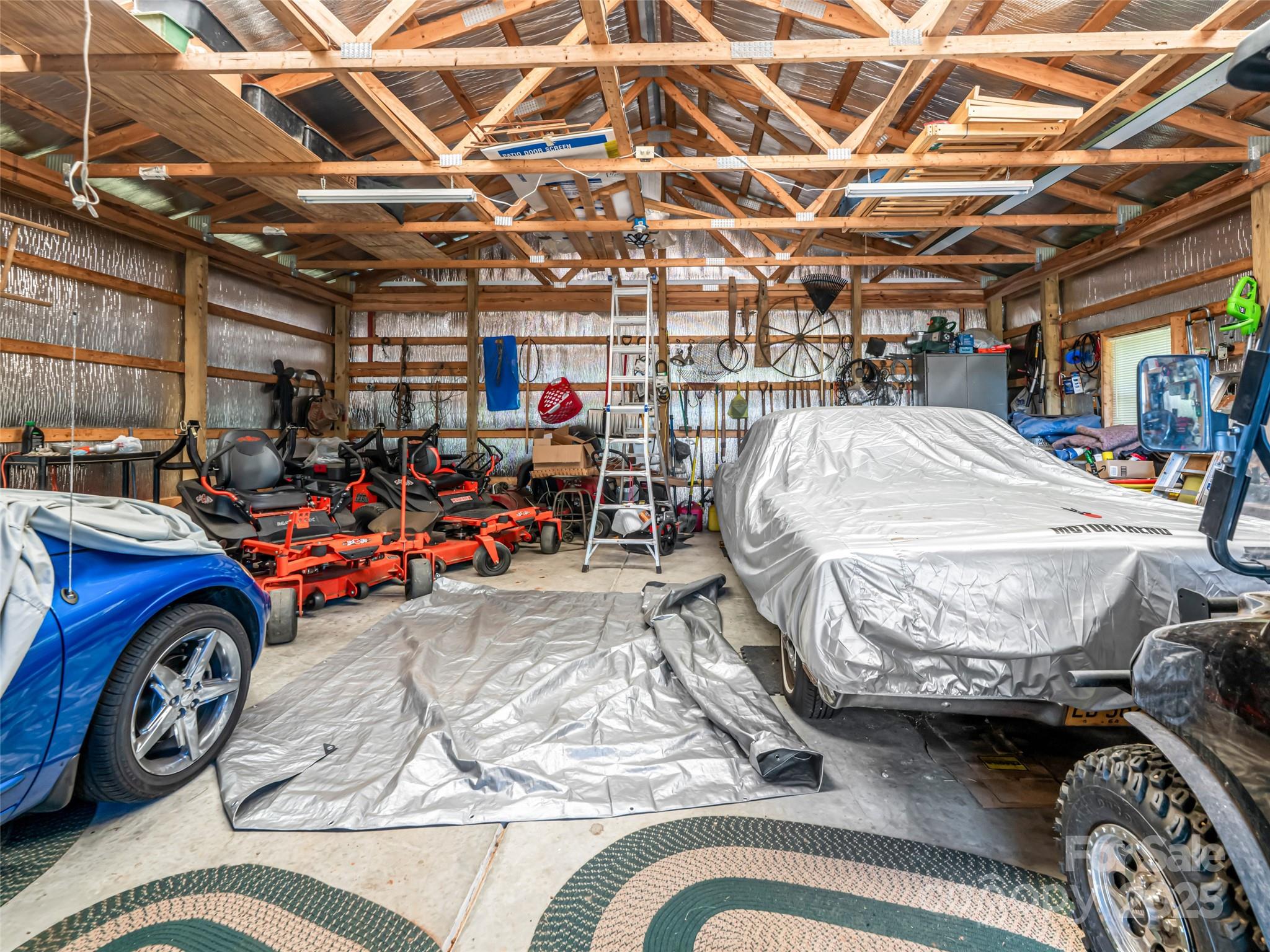129 Melrose Lake Road Saluda, NC 28773 - Photo 32 of 48 a view of parking garage with cars