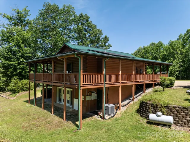 a view of a deck with a large window and plants