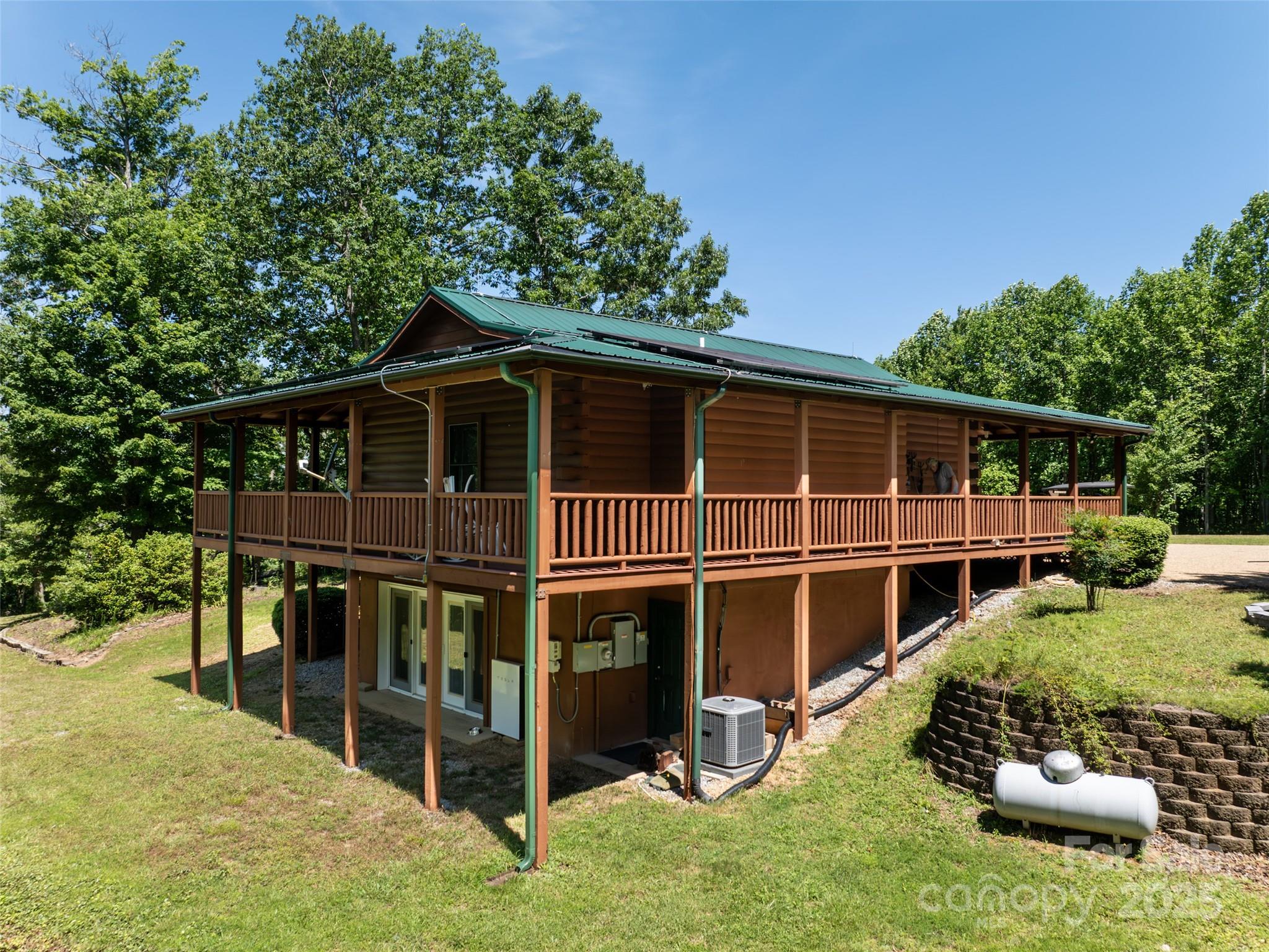 129 Melrose Lake Road Saluda, NC 28773 - Photo 37 of 48 a view of a deck with a large window and plants