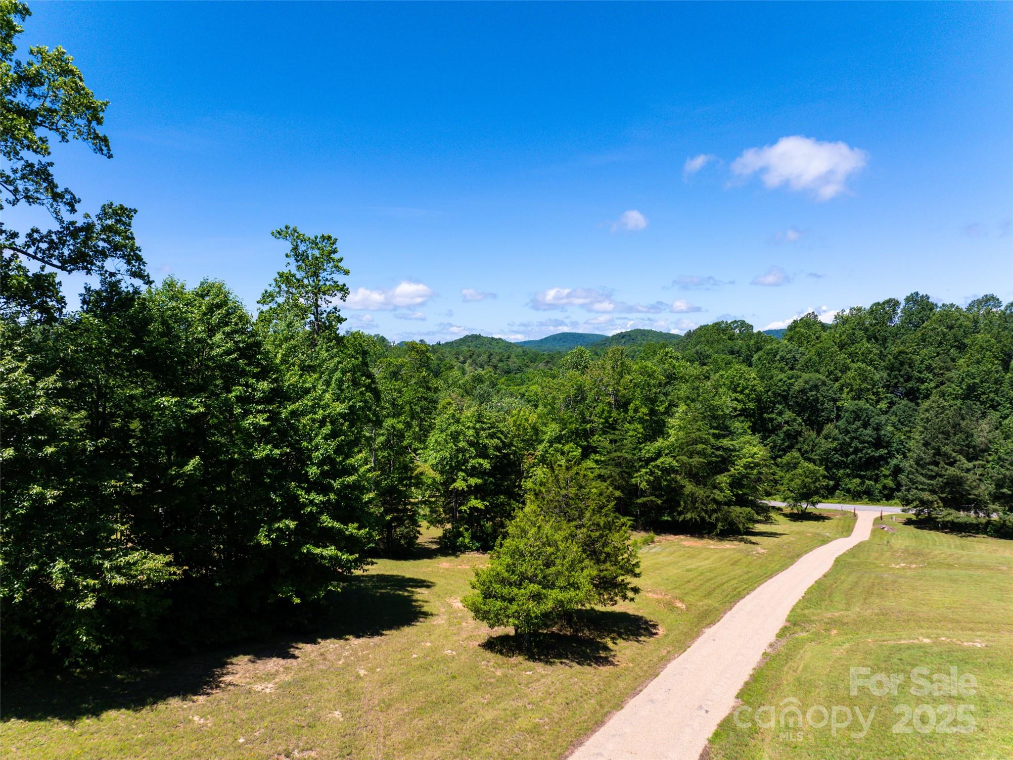 129 Melrose Lake Road Saluda, NC 28773 - Photo 43 of 48 a view of a lake with houses in the background