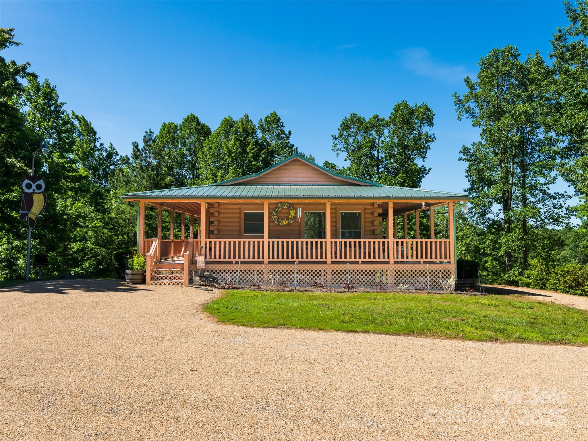 129 Melrose Lake Road Saluda, NC 28773 - Photo 6 of 48 a front view of a house with a yard and garage