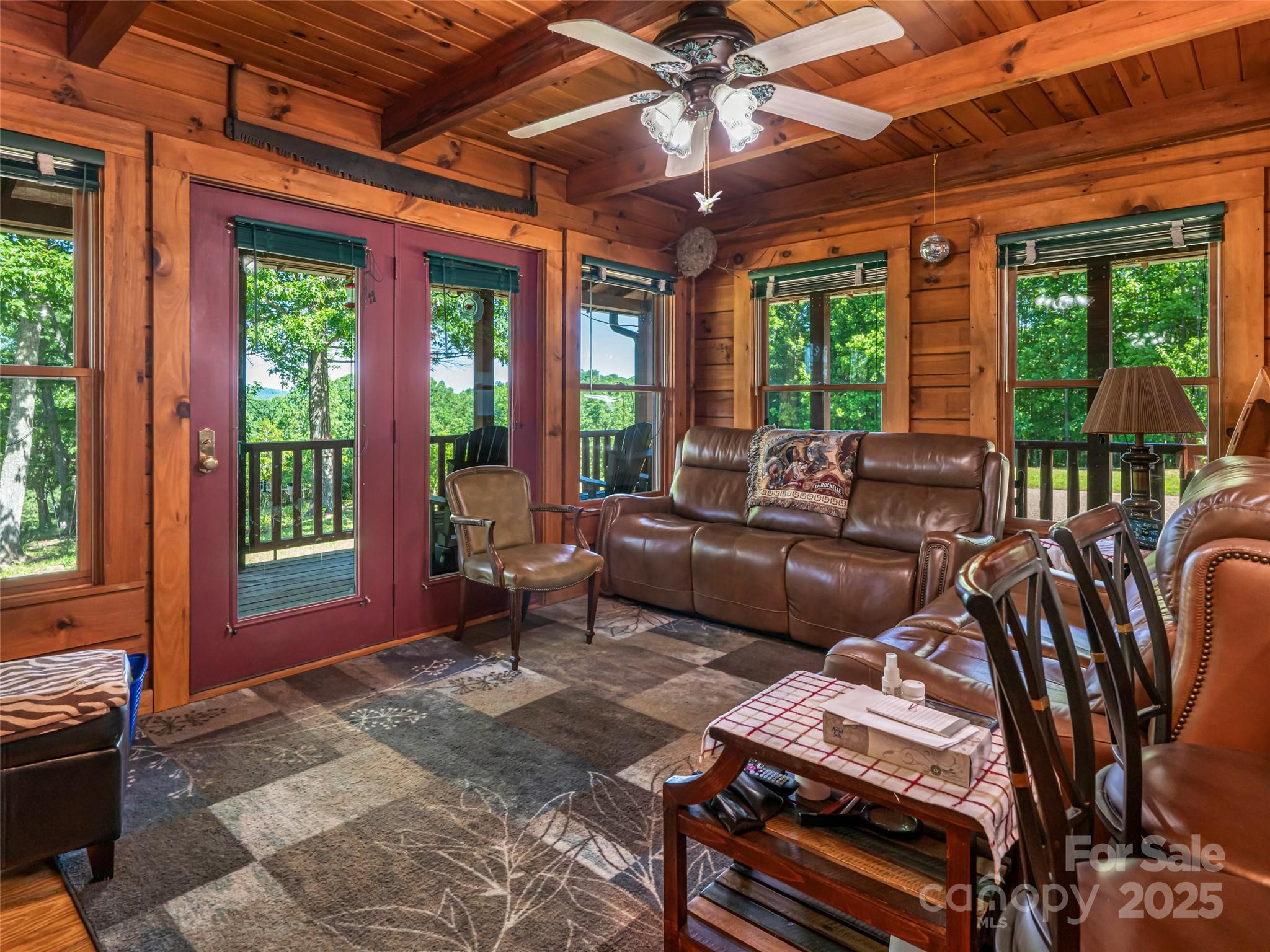 129 Melrose Lake Road Saluda, NC 28773 - Photo 10 of 48 a living room with furniture and large windows