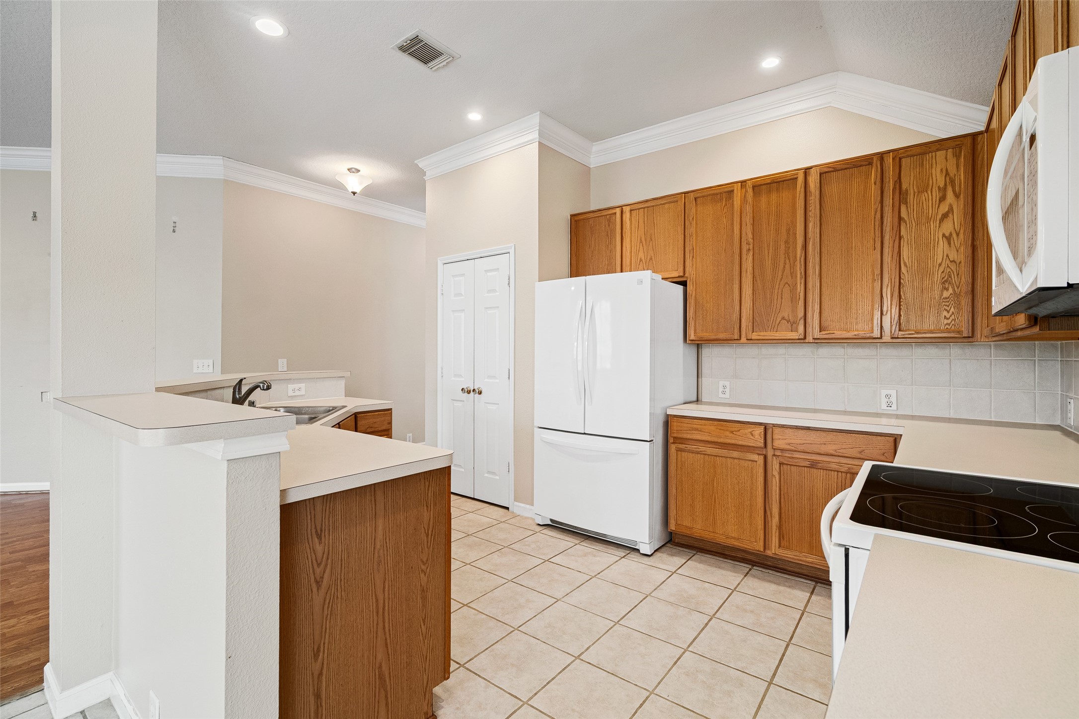 2218 Louetta Brook Lane Spring, TX 77388 - Photo 5 of 18 a kitchen with a sink a refrigerator and a stove top oven