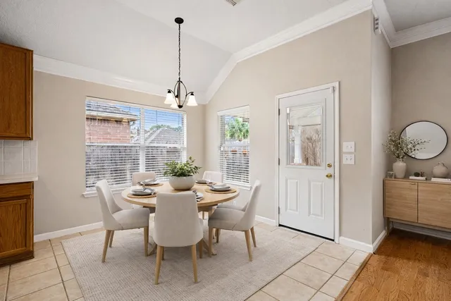 a view of a dining room with furniture wooden floor and chandelier