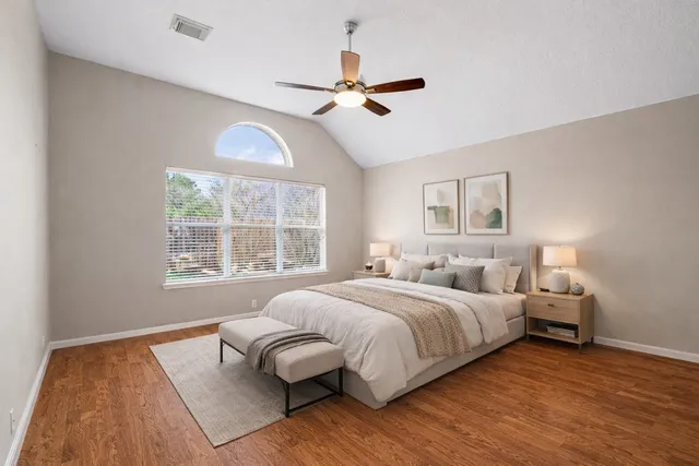 a bedroom with a bed and a large window