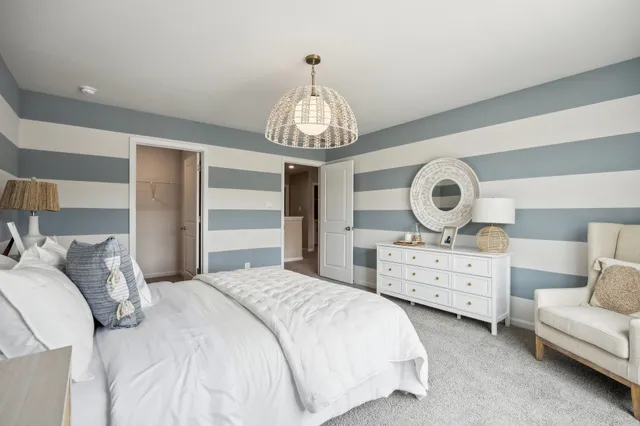 a bedroom with bed and a chandelier