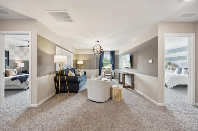 a living room with furniture and a chandelier