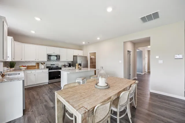 a kitchen with a table and chairs in it