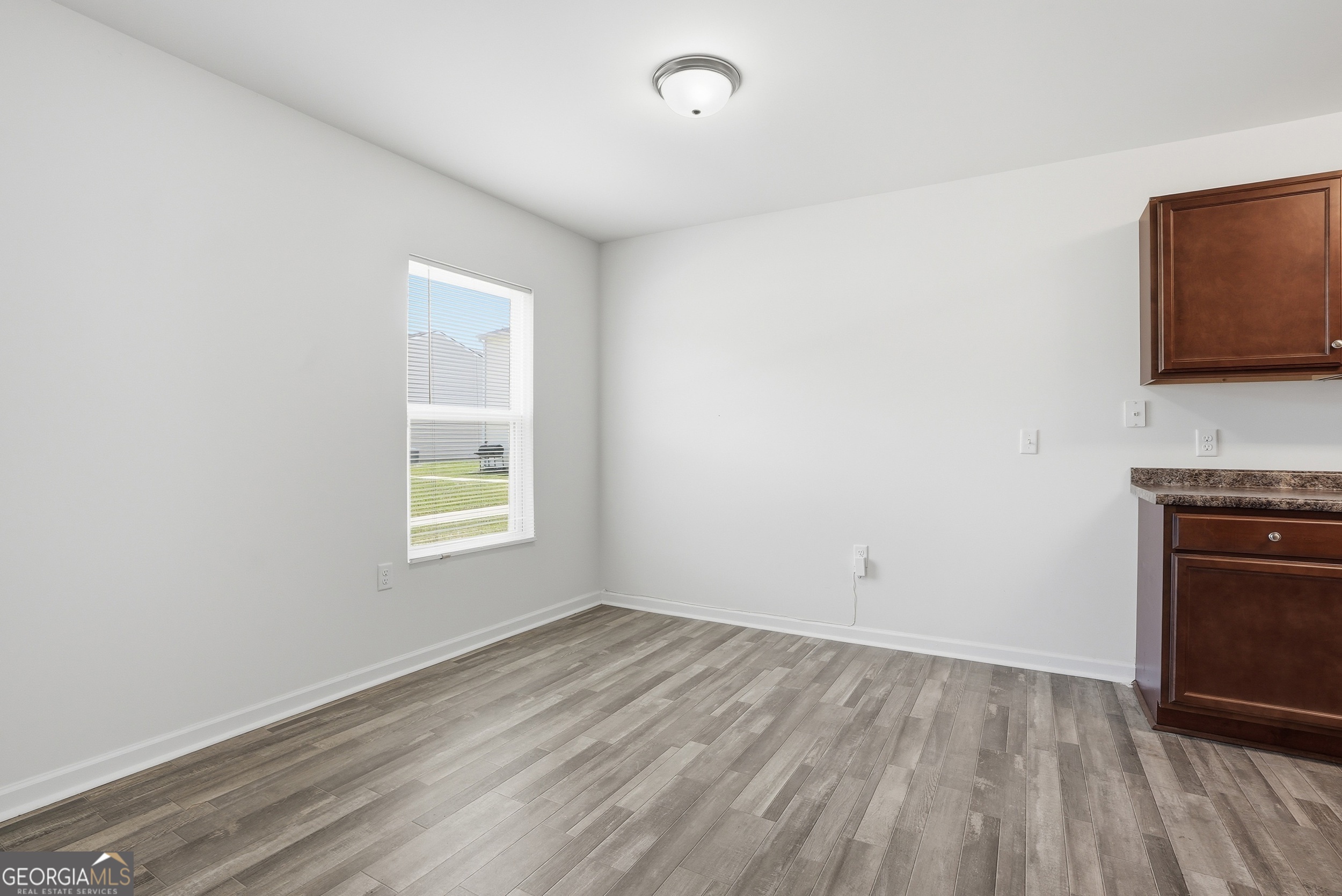 225 Rendell Lane Hinesville, GA 31313 - Photo 13 of 33 a view of empty room with wooden floor and fan