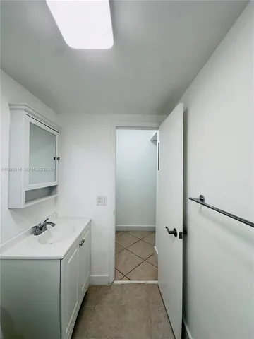 a bathroom with a sink and mirror