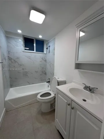 a bathroom with a sink a toilet and bathtub